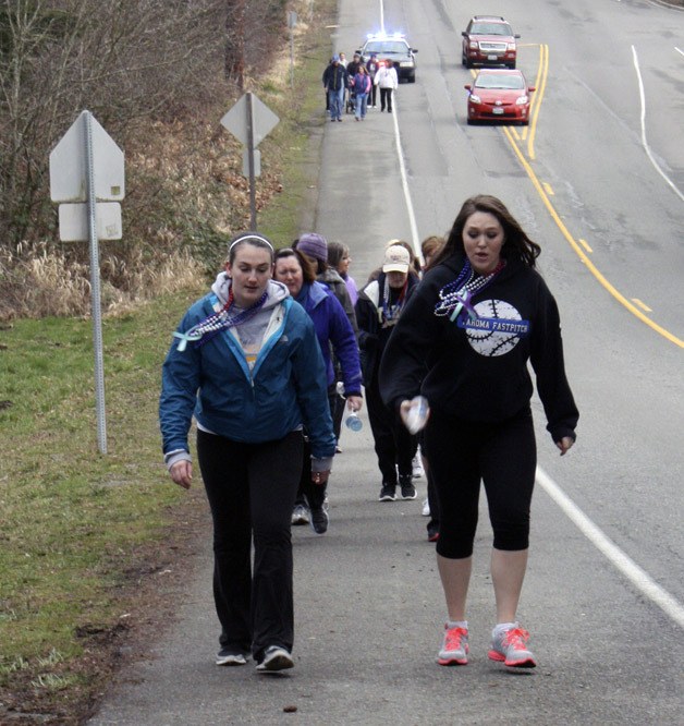 Haley Alderson and Brooke Proctor lead the group of community members that turned out for the 5K Out of the Darkness walk Feb. 23 at Tahoma High.