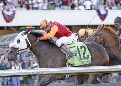 Gallyn Mitchell riding Assessment won the Longacres Mile Sunday at Emerald Downs.