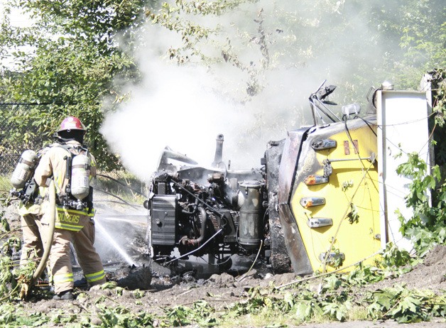 Firefighters from Maple Fire and Safety put out the fire which erupted after the dump truck crashed.