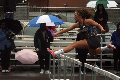 Tahoma junior Savanna Haverfield leaps during the 100 hurdle race. Haverfield took first with a time of 16.22 seconds.