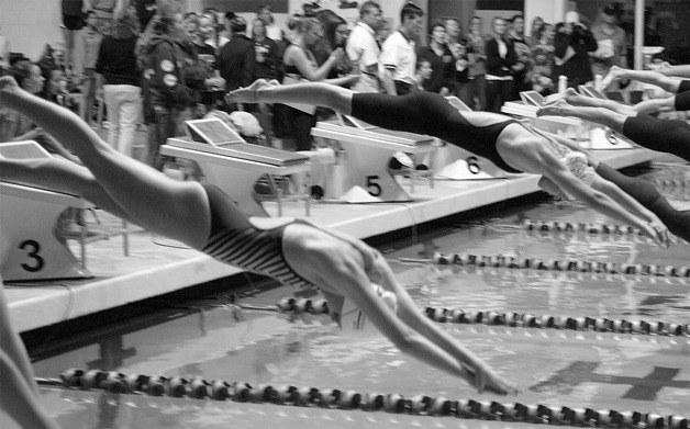 Jessica Miller and Lindsey Hanger dive off the blocks in 100 free finals Saturday at the state meet.