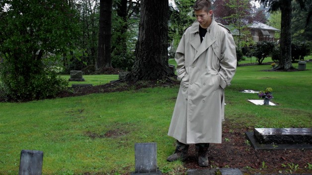 David Stoecker stands next to a grave in the Maple Valley Hobart Cemetery during the final scene of “The Last One.”