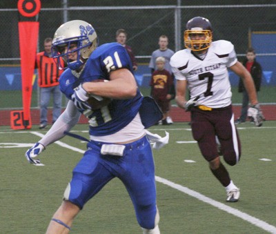 Senior Riley Owens for Tahoma turns the corner with Jens Johnson from South Kitsap in pursuit.