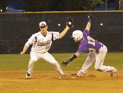 Kentwood short stop Bryant VanEngelenburg gets a cutoff throw from home to tags out Puyallup's Andrew Barry as he tries to steal second late in the 7th inning Saturday