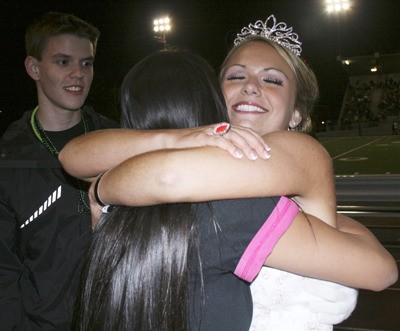 Cecily Gray gets a hug form Kimmie Pham after being crowned the 2010 Kentwood homecoming queen Friday at French Field.