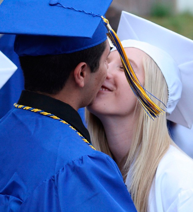 Tahoma graduates Taz Campos and Shayden Freebairn share a kiss before the ceremony June 11 at the White River Amphitheater.
