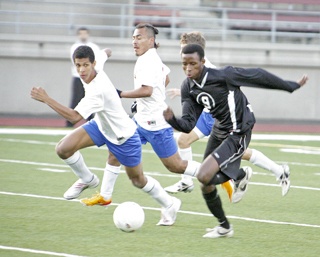 Kentlakes Allen Shour breaks away from three Kent-Meridian defenders to move upfield for a shot on goal.