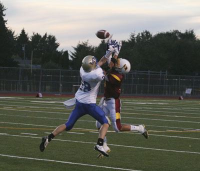 Tahoma receiver Brody Lunquist battles for the ball against Jadon Sand from Thomas Jefferson Thursday in the opening game of the season. Tahoma lost 21-7.
