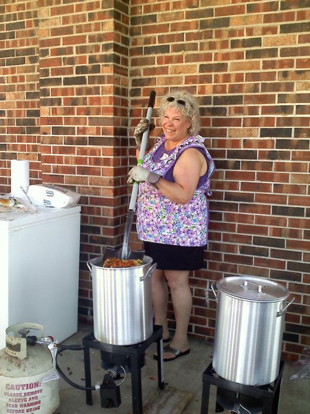 Ginger Passarelli stirs pasta with a sanitized shovel for tornado victims in Joplin