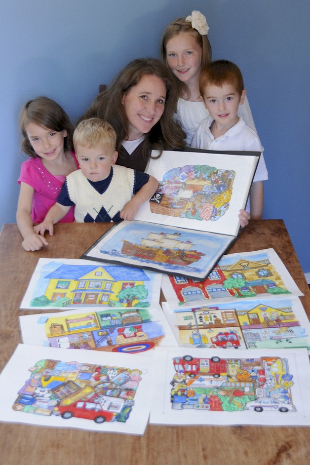 Maple Valley resident Vicki Lewis with her children and one of her Flipzles. Flipzles are painted on both sides so it can be used as both a puzzle and a toy. Courtesy photo