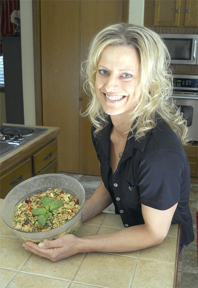 Marci Adelsman shows off her dish for a chicken and brown rice salad she entered in a cooking contest.