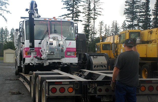 A Vactor 2100 truck is loaded onto a trailer Nov. 13 after Tina and Cory McDonough pinked out and sold it to donate a portion of the proceeds.