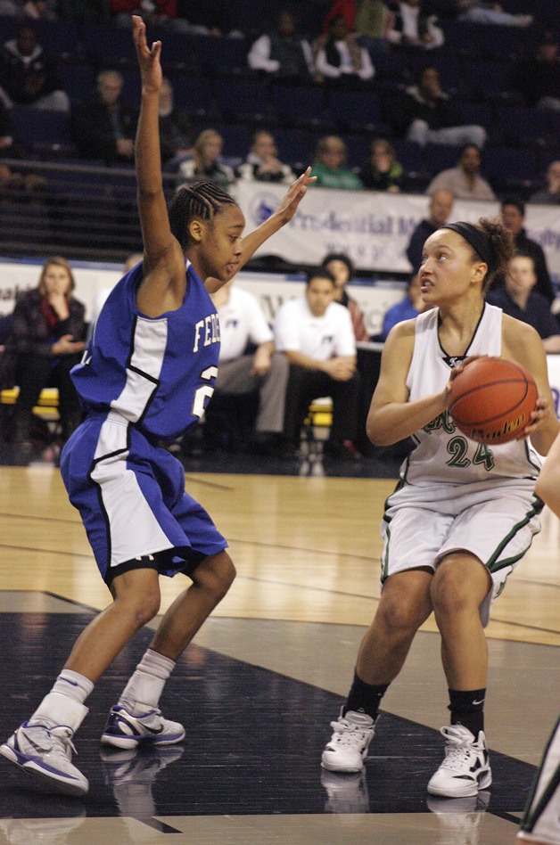 Kentwood’s Alycea DeLong with the ball as a Federal Way player defends her in a game at ShoWare Center on Monday.
