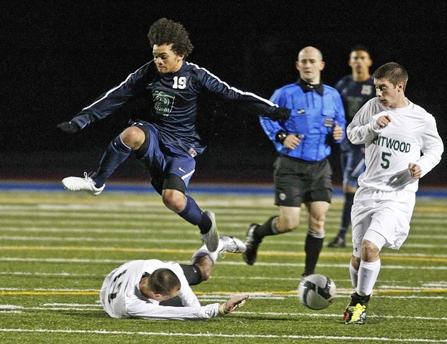 Beamer’s Kelvin Horne leaps over Kentwood’s Keaton Gray in a game on May 11 which the Conks won 1-0.