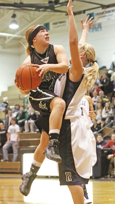Kentwood's Kylie Huerta charges the lane and gets a foul from Auburn Riverside's Mercedes Wetmore
