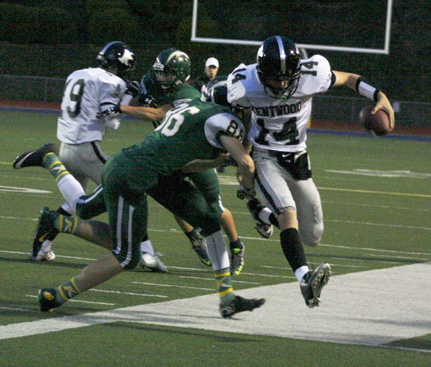 Kentwood senior Brian Campbell runs up field on a quarterback keeper until he is pushed out of bounds Thursday.