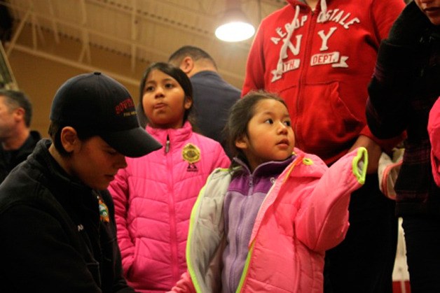 Kids receive their new winter coat during Operation Warm last year.