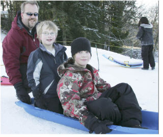 The heavy snow and bitter cold leading up to Christmas made roads treacherous and closed schools. But the conditions were also fun for people such as Joe Larson and his children Chance and Cooper