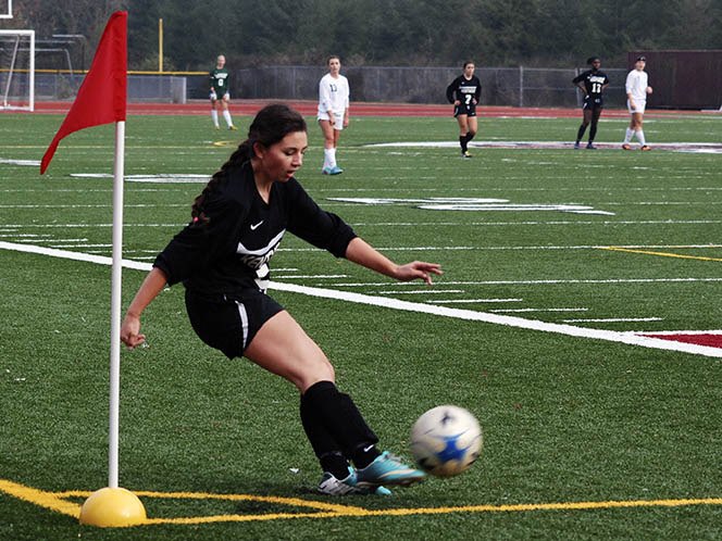 Kentwood's Kaylie Gladwell boots the corner kick late in the first half against Kentlake Thursday afternoon. Shannon Parmley put the ball in the net for the Conquerors as they beat the Falcons 1-0.