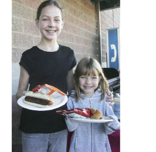 Reilly and Quincy O’Brien of Maple Valley were among the people who bought hot dog lunches in a breast cancer research fund-raiser sponsored by the local John L. Scott Real Estate agency last Saturday. October is Breast Cancer Awareness Month. For related stories