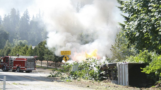 The dump truck burns as the Maple Valley Fire and Safety arrive on the scene.