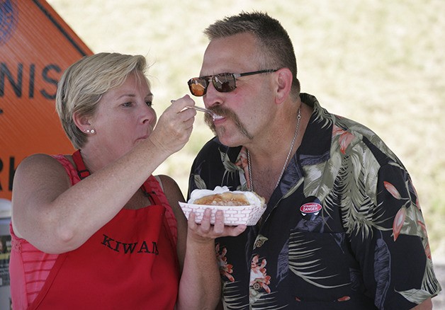 Ken and Cindy Brown enjoys strawberry shortcake at the Black Diamond-Maple Valley Kiwanis booth Saturday during Black Diamond Miners Day.