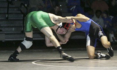 Kentwood’s Teddy Zografos works over Jayson De La Cruz from Kent-Meridian in the 130 pound weight class. Zografos went on to pin De La Cruz as the Conquerors came away with the dual meet win Jan. 14.