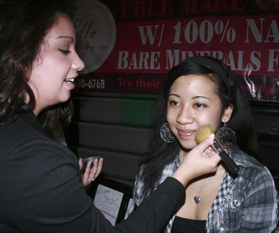 Kentwood sophomore Latasha Averett gets a first hand lesson in makeup application from Clair Hosa of Elle Spa.