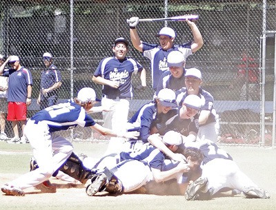 Kent Magic clears the dugout and rushes the mound after the last out against Redmond to win the Senior Little League Championship 9-4 Saturday