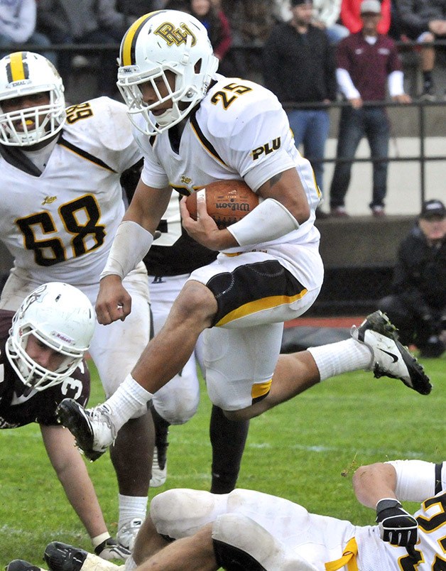 Niko Madison leaps over a teammate during a game for Pacific Lutheran University.