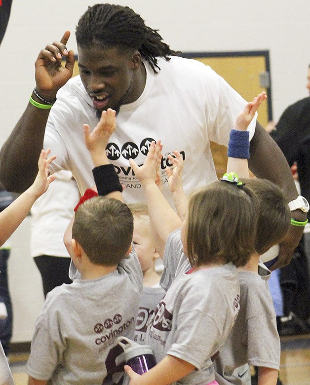 Demitrius Bronson leads a cheer while coaching  his son’s recreational basketball team at Cedar Heights Middle School Jan. 10. Bronson