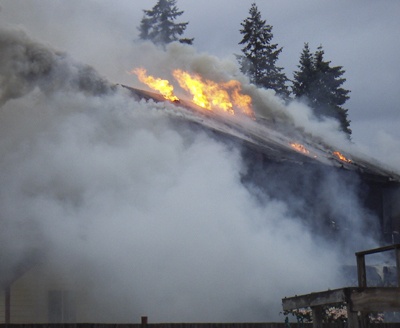 A home in Maple Valley burned Monday morning. The cause was believed to be charcoal briquettes falling on a wood deck.