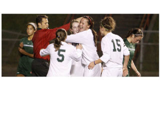 Kentwood’s Kiana Kraft gets a hug from teammate Shannon McNally after scoring last week against Beamer. The Conks opened state on Wednesday against Shorewood.