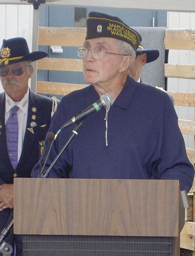 Chuck Hardaway addresses a gathering at the Farmers Market commemorating veterans Aug. 22