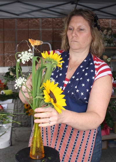 Robin Erickson with Carol's Maple Valley Floral at the farmers market Aug. 13.