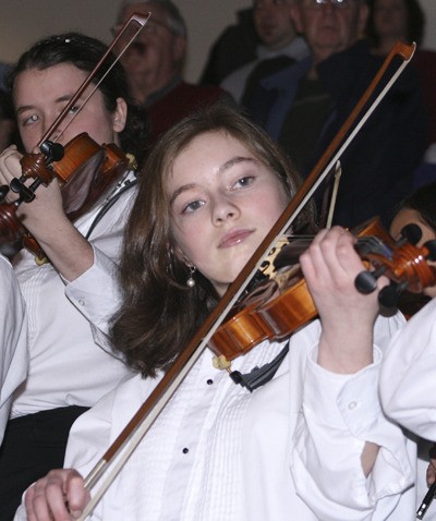 The Maple Valley Youth Symphony Orchestra play the national anthem at the Seattle Thunderbirds' game at the ShoWare Center in Kent Saturday.