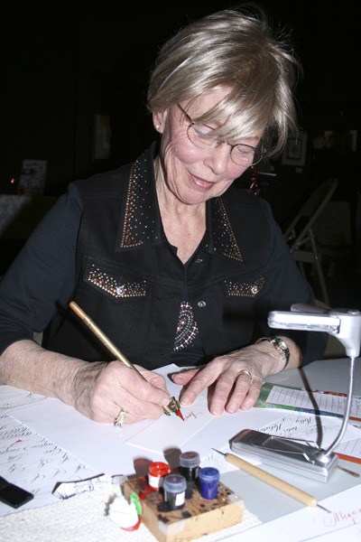 Sherill McBroom displays her calligraphy talent during the Sally Penley Valentine Calligraphy Rotation at the Maple Valley Arts Center Feb. 12.