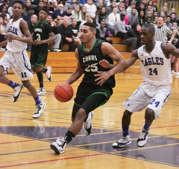 Kentwood guard Darius LuBom drives the lane against Federal Way Saturday during the 4A district boys basketball championship. The Conks lost 74-56.
