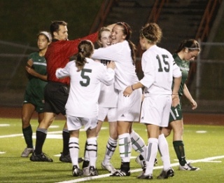 Kentwood's Kiana Kraft is congratulated by a host of teammates after scoring one of her two goals in Wednesday night's 3-0 win over Beamer.