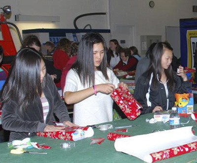 The Toys for Joy program drew more than 100 volunteers to wrap Christmas presents for children.