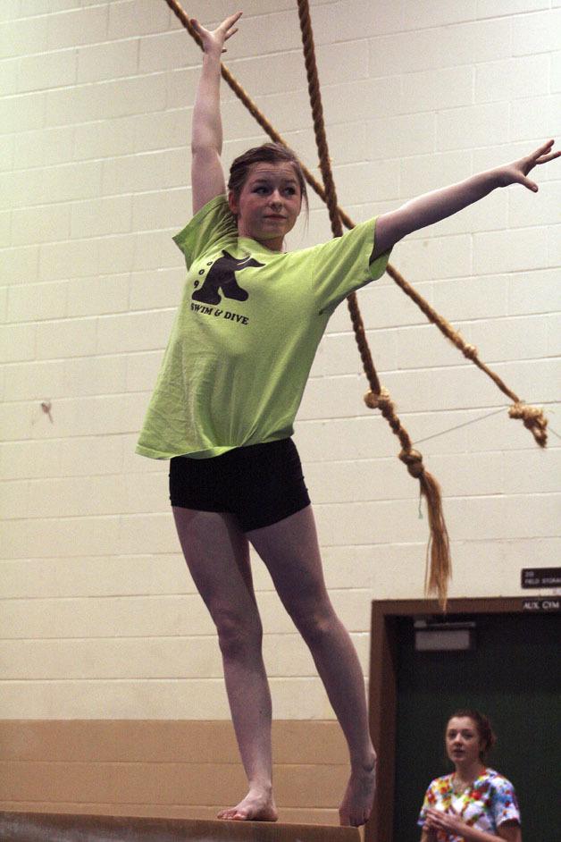 Kentwood's Zoe Krambule practices on the balance beam in the school's mat room. Krambule started gymnastics when she was 3.