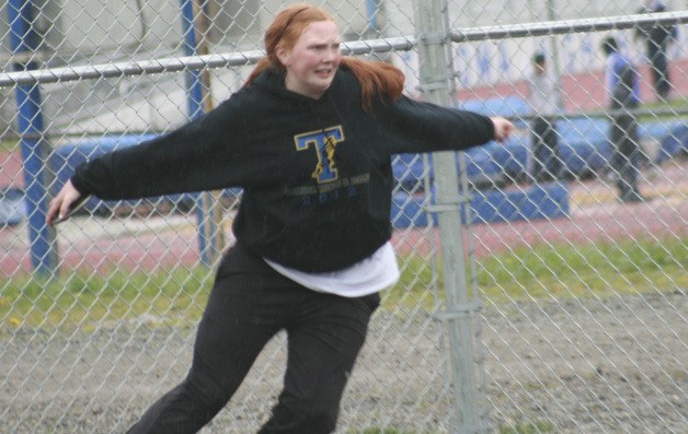 Tahoma junior Kylie Eager practices throwing the discus during the meet against Kent-Meridian.