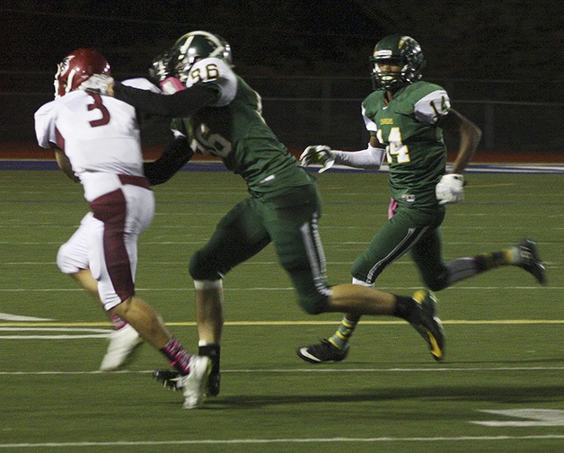 Kentlake junior Larry Alar is chased down by a Kentridge defender during the Falcons’ 24-7 loss to the Charger.