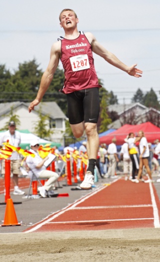 Kentlake's Zach Smith flies through the air during the long jump competition at last week's 4A state track and field championships.