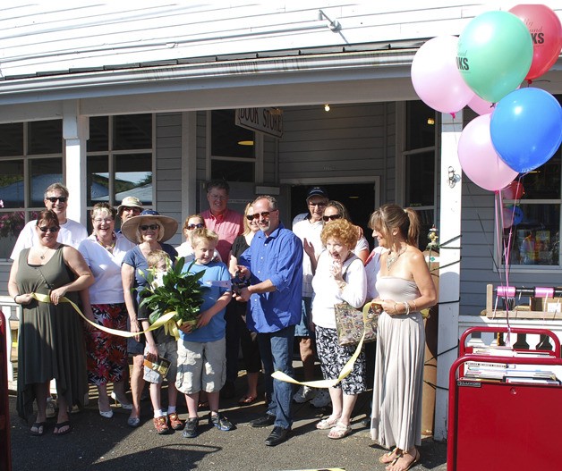 Finally Found Bookstore owner Todd Hulbert holds a ribbon cutting to celebrate the grand opening of the store Saturday