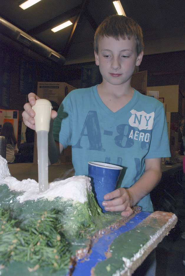 Sixth-grader Devin Reice adds a solution to one of the mountains in his ‘Active Volances of Washington’ project for the Cedar Valley Elementary Science Fair April 5. More than 90 projects were on display during the science fair in the gym. Reice’s project was one of the judges’ picks.