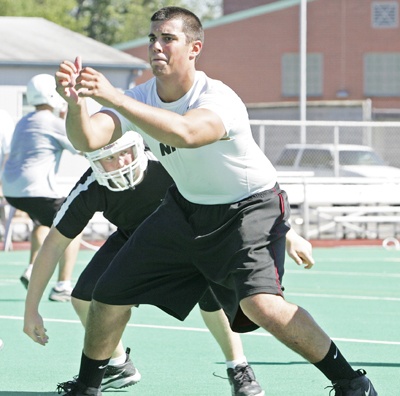 Kentlake senior Mike Holzberger goes through a lineman drill during practice.