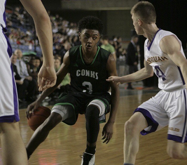 Rayvaughn Bolton brings the ball up for Kentwood against Issaquah at the Tacoma Dome in the 4A boys basketball state tournament.