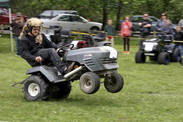 A Maple Valley man pops a wheelie during the lawn mower races at Maple Valley Days on Saturday