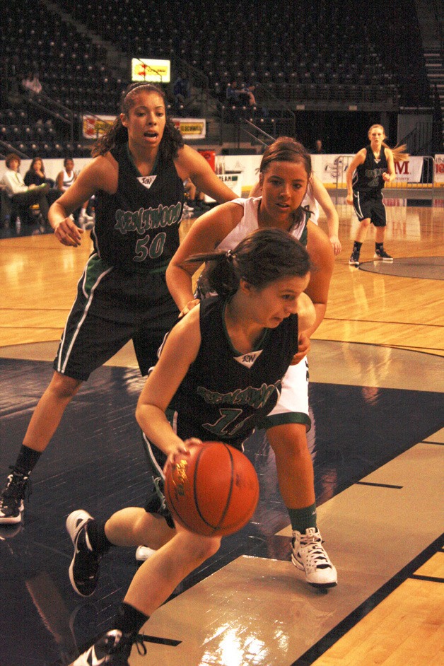 Kentwood sophomore  Ashley Roslma attempts to dribble the ball away a Federal Way player